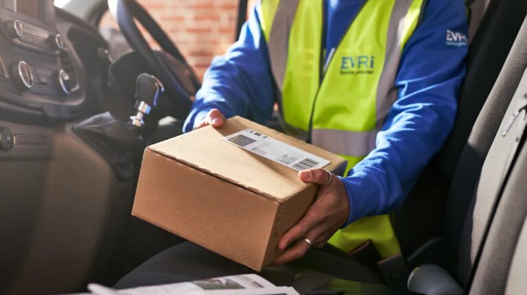 Evri expands delivery partnership with Debenhams Group An Evri employee handles a parcel in the front cabin of a delivery vehicle, while wearing a yellow high-vis vest