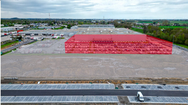 The future extension of the sorting center building (red) and the future truck bays and truck parking (light gray)