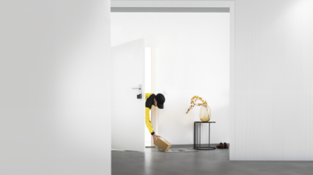 Austrian Post launches in-house delivery service Austrian Post delivery worker placing parcel inside recipient's home.