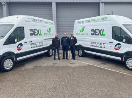 DEXL staff with two electric delivery vans