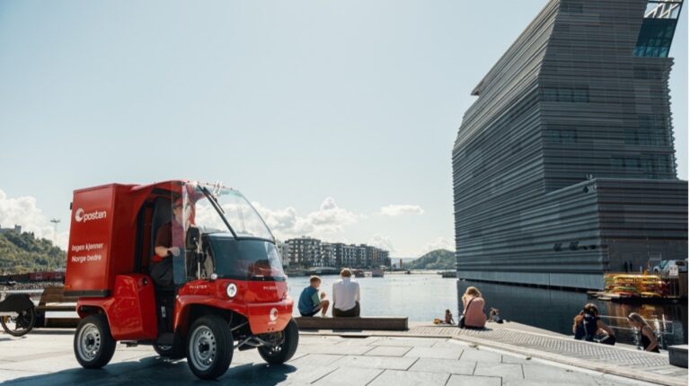 EXCLUSIVE FEATURE: Norway Post’s transformation journey Posten Norge vehicle outside building on quayside