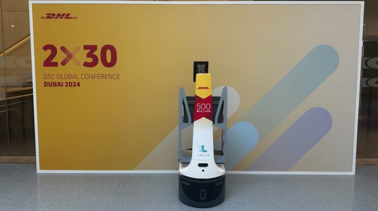 LocusBot in front of DHL branded board