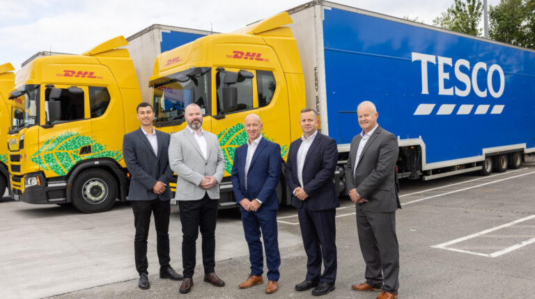 DHL Supply Chain rolls out 50 biomethane trucks in Ireland DHL and Tesco staff in front of the new trucks