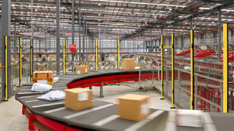Australia Post’s Post26 strategy starts to pay off with improved financial results Australia Post parcel facility with parcels on sorting conveyor.