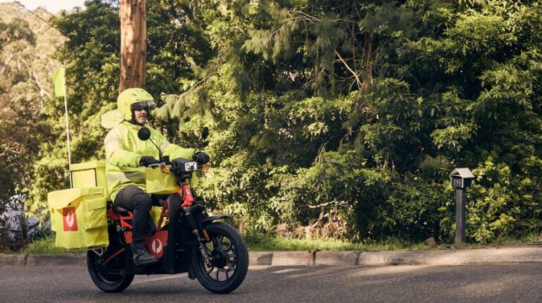 Australia Post rolls out electric motorbike fleet Australia Post delivery driver on the new UBCO electric motorbike.