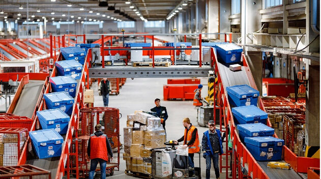 Nova Post sorting center with blue parcel boxes on red sorting line