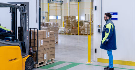 UPS announces acquisitions to expand healthcare logistics capabilities Forklift with UPS Healthcare packages on, worker standing nearby