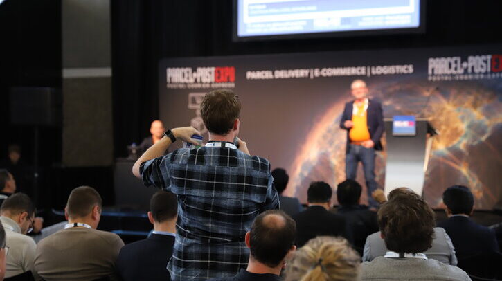 Parcel+Post Expo Innovation Forum highlights – editor’s picks Man in audience standing to ask question during conference session.