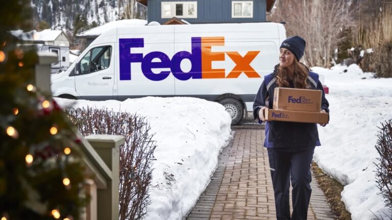 European peak parcel volumes to rise to 6.2 million in 2024, FedEx forecasts Female FedEx worker carrying parcel to the door with snow on the path and FedEx van in the background