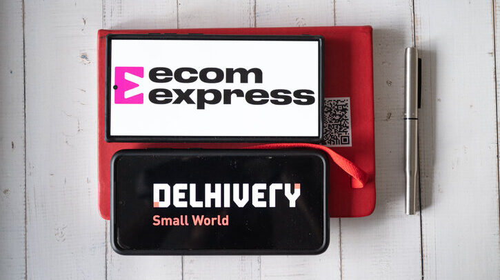 Delhivery takes control of Ecom Express to boost Indian e-commerce growth Delhi, India - 5th Apr 2025: Mobile phone showing the app screen for ecommerce logistics startup ecom express which was acquired by Delhivery showing business setting with diary and pen