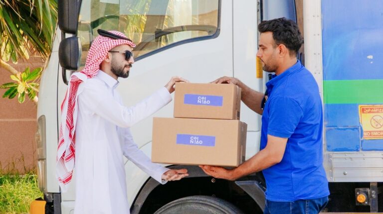 Cainiao driver handling over parcels to customer in Middle East