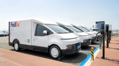 FedEx adds more electric vehicles to Korean fleet A row of FedEx electric vans are parked at charging points