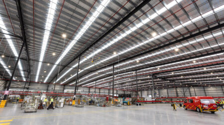 Australia Post rolls out sustainable lighting upgrades in Queensland The interior or an Australia Post warehouse with sustainable lighting fixtures