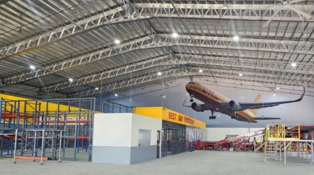 DHL Express relocates Cebu Gateway to accommodate rising export volumes The interior of the relocated and expanded Cebu Gateway in the Philippines, with sorting equipment in the foreground and a painting of a DHL cargo plane on the far wall
