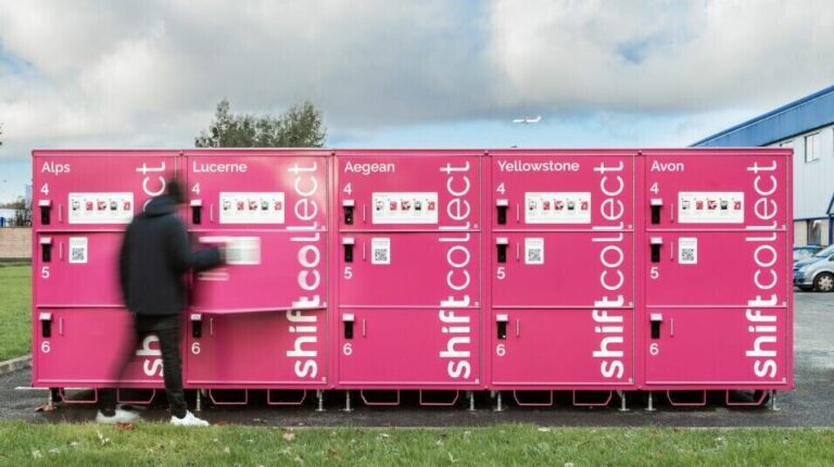A block of pink shift Collect parcel lockers in a parking lot location outside a building