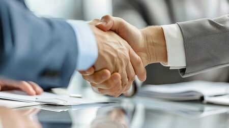 DHL and Itochu partner to expand logistics in sub-Saharan Africa Two men shake hands after completing a business deal