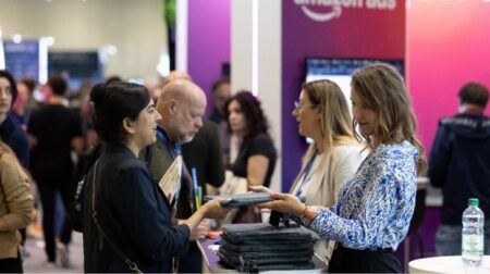 FEATURE: eCommerce Expo 2025 – real challenges, smart solutions, future-facing commerce The show floor at a trade show with various people animatedly discussing new products and solutions