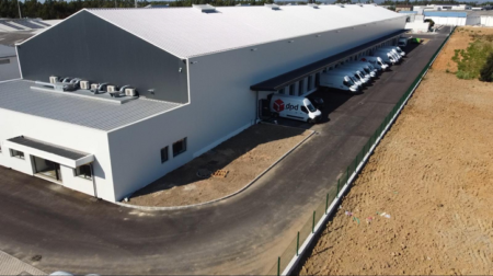 DPD invests €4.5m in new Portuguese logistics center An exterior shot of the new Leira depot in Portugal, with DPD vans and trucks out the front and a blue sky above