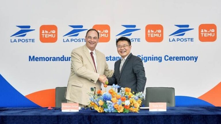 Philippe Dorge, La Poste’s executive vice-president and chief operating officer of the Services-Mail-Parcels business unit, and Sun Qin, president of Temu, shake hands at a signing ceremony for the MOU