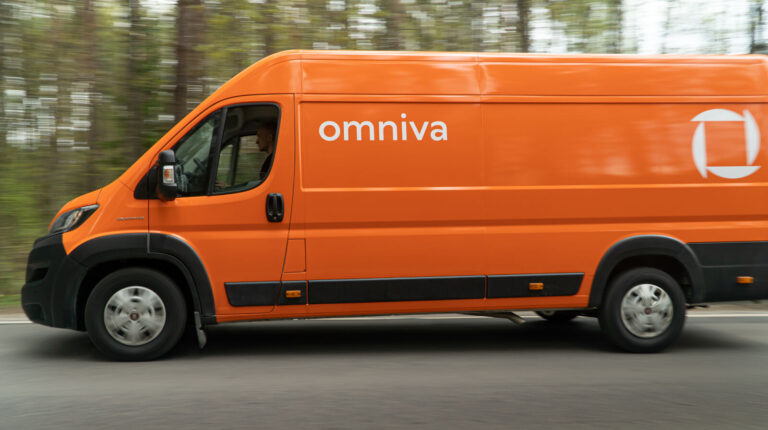 Omniva bids for Lithuania’s universal postal service contract An orange delivery van with Omniva written along the side drives down a tree-lined road