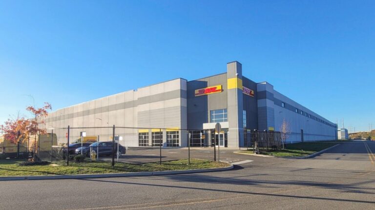 DHL Express announces US$90m investment in New York City region The exterior of a large DHL Express facility. There is a blue sky above