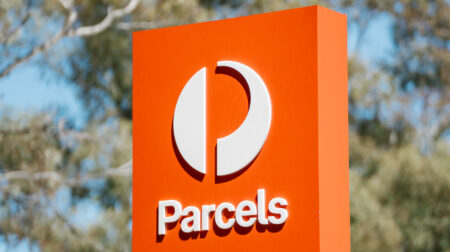 Australia Post logo and the word 'parcels' on an exterior sign.