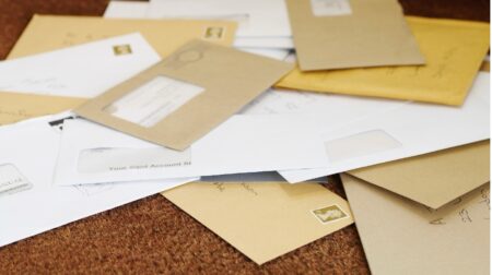 Pile of letters on a doormat.