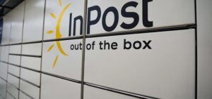 A bank of grey InPost lockers with the company logo on the outside.