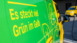 An Austrian Post electric felivery vehicle with yellow and green branding to illustrate its sustainability credentials.