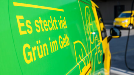 An Austrian Post electric felivery vehicle with yellow and green branding to illustrate its sustainability credentials.