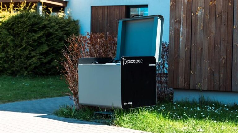 An Omniva at-home Picapac parcel locker in the front garden of a residential property.