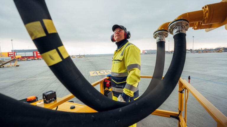 DHL and IAG Cargo expand SAF agreement A ground support worker wearing high vis clothing and ear defenders helps fuel an aircraft on the tarmac.