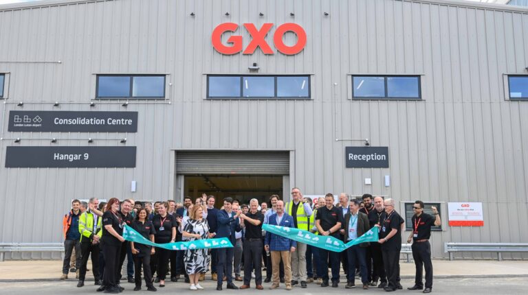 Respresentatives of GXO Logistics and London Luton Airport cut the ribbon to open the new consolidation center at the London airport.