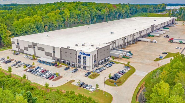 Stord’s main fulfillment warehouse, located outside Atlanta. It has green verges on three sides and trees to the rear.