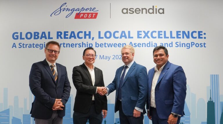 Representatives of Asendia and Singapore shake hands at the signing of the partnership.
