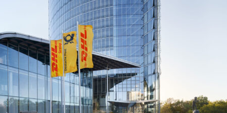 DHL offices with company flags flying outside.