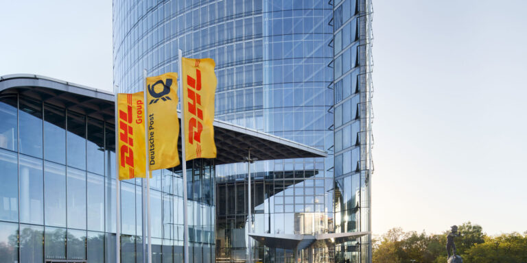 DHL offices with company flags flying outside.