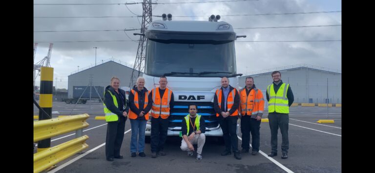 DP World launches second phase of electric HGV trial at Southampton DP World and Southampton Port staff stand in front of a DAF electric vehicle.