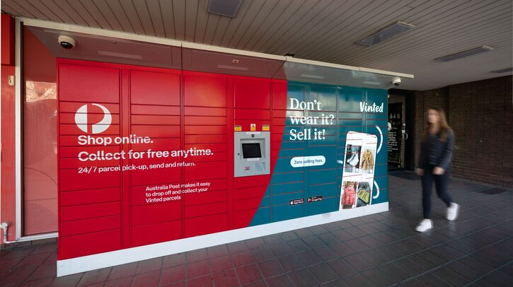 A bank of red Australia Post parcel lockers.