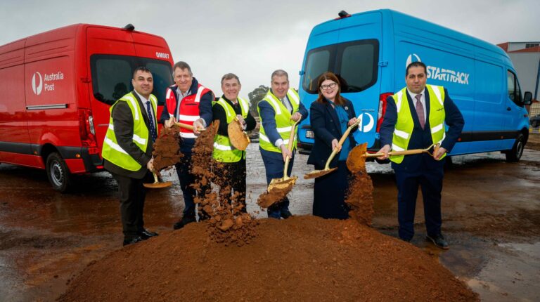 Representatives of Australia Post, STarTrack and Pelligra hold shovels and wear high-vis jackets as they attend a ceremony to mark the groundbreaking of the new A$500m Adelaide parcel hub.
