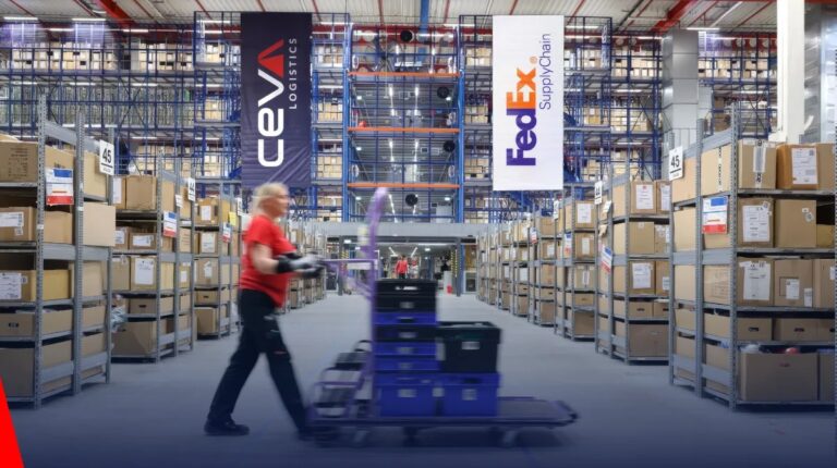 CMA CGM to acquire FedEx Supply Chain for US$1.4bn A warehouse with tall shelves of goods and stock, with a staff member in the foreground and CEVA and FedEx brand logos superimposed across the top of the image.