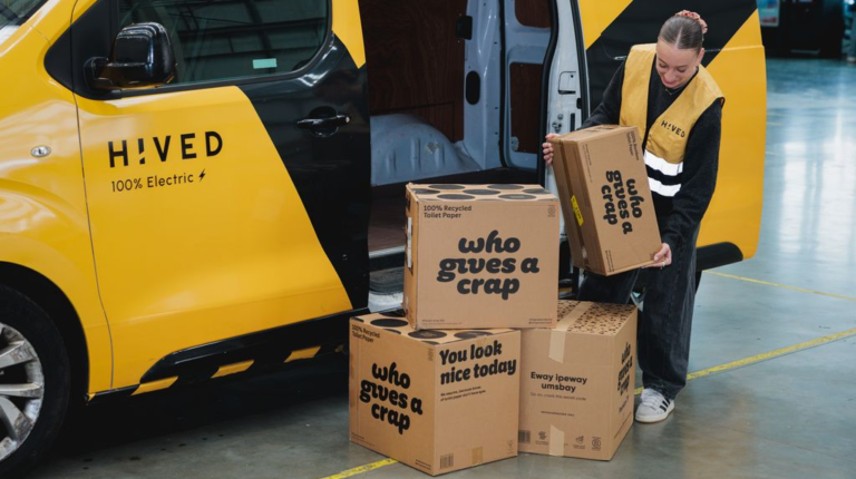 Who Gives A Crap partners with Hived for lower-emission UK deliveries Boxes of Who Gives A Crap toilet paper are loaded into a yellow Hived delivery van.