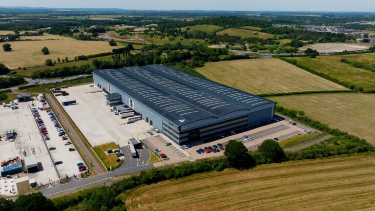 DP World to take on six UK grocery logistics sites from GXO Aerial view of a GXO logistics site in the UK that is to be taken on by DP World.