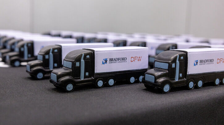 Dallas Fort Worth International Airport opens logistics facility to support expanded dining, shopping and lounge options A row of toy Bradford Airport Logistics trucks.